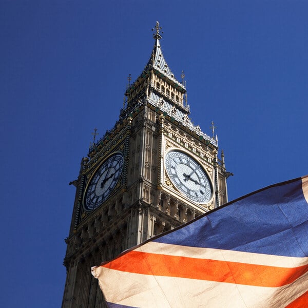 Big Ben clock tower with a union jack flag just in frame
