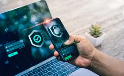 An image of both a laptop screen and mobile device showing security symbols