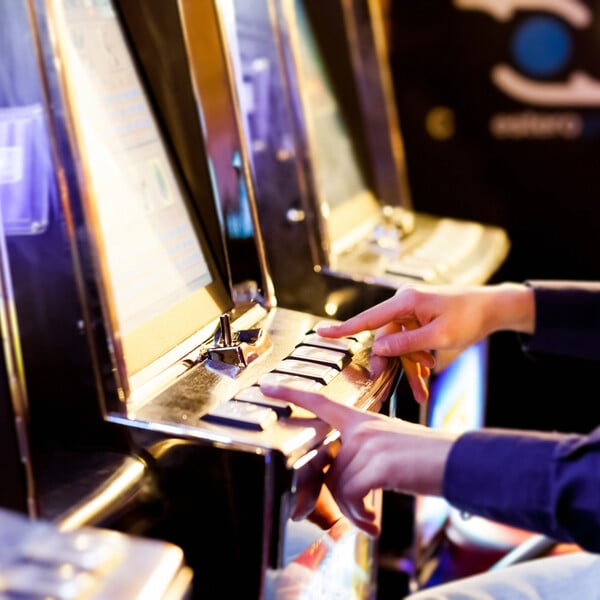 Man using an electronic slot machine